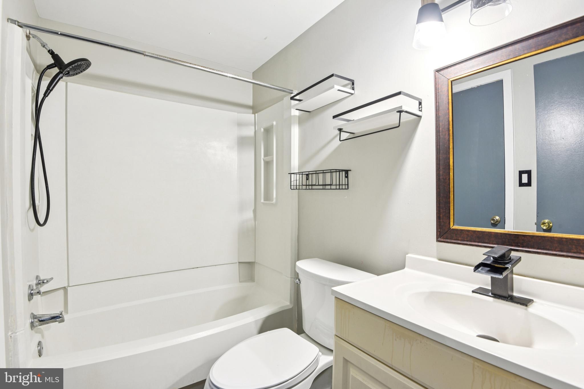 9717 Hellingly Place, Unit 48 Gaithersburg, MD 20886 - Photo 28 of 32 a bathroom with a sink toilet and shower