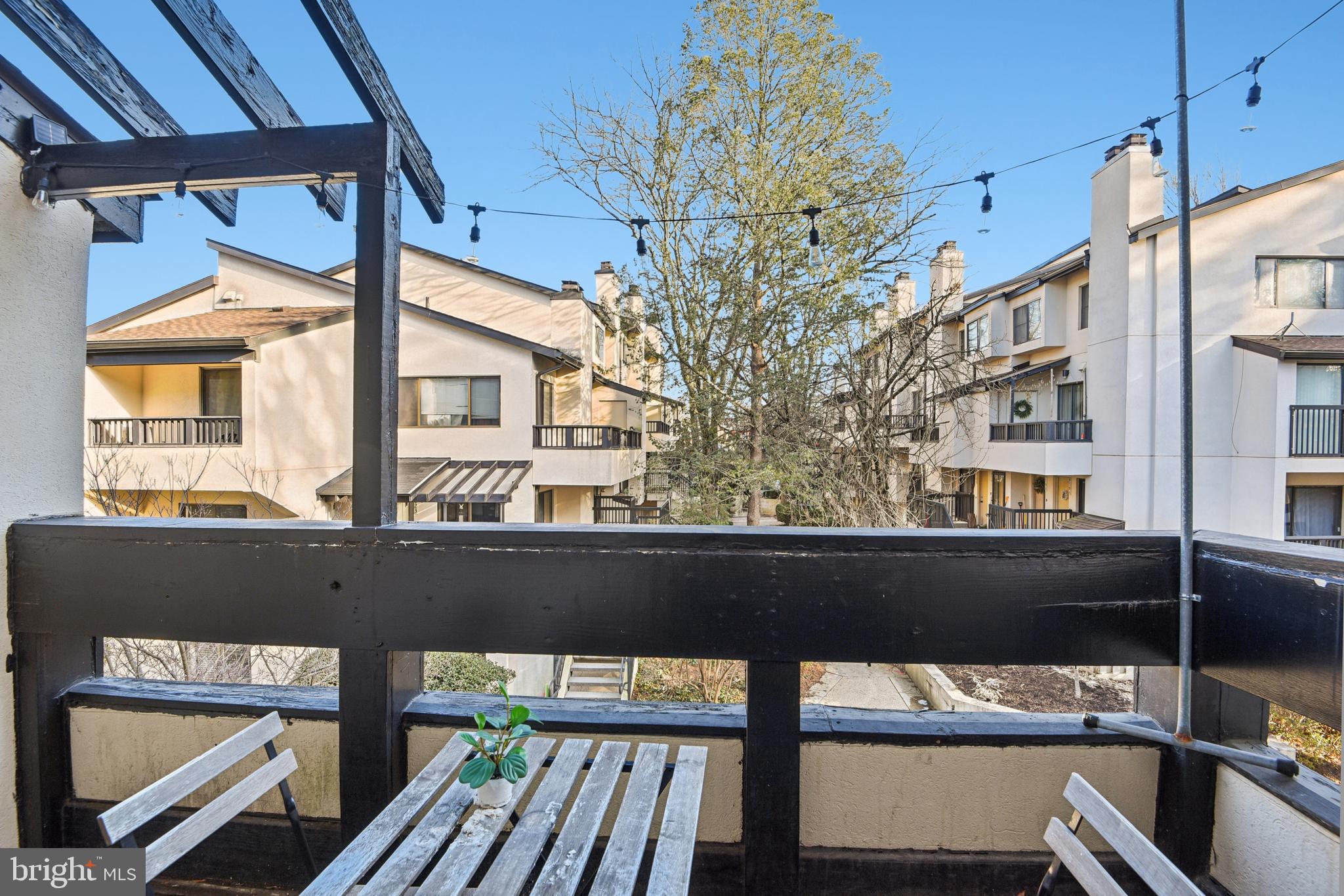 9717 Hellingly Place, Unit 48 Gaithersburg, MD 20886 - Photo 29 of 32 a view of a balcony with furniture and large windows