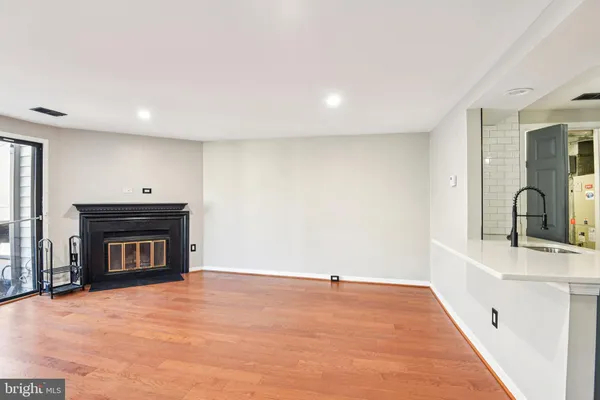 a view of an empty room with a fireplace and a window