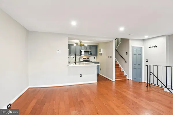 a view of a kitchen with wooden floor and electronic appliances