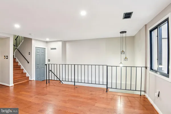 a view of a hallway with wooden floor and entryway