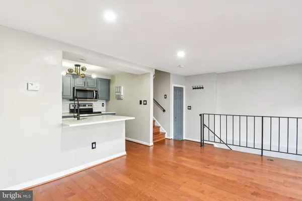 a view of a kitchen with flat screen tv and refrigerator