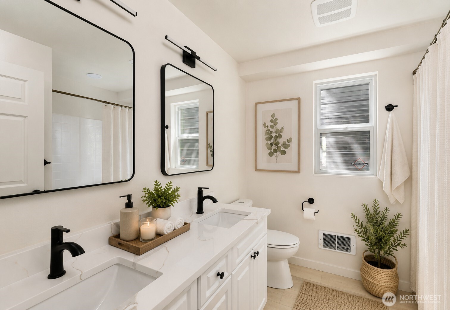 7605 Northeast Hidden Cove Road Bainbridge Island, WA 98110 - Photo 7 of 36 a bathroom with double vanity sinks a toilet a mirror and shower