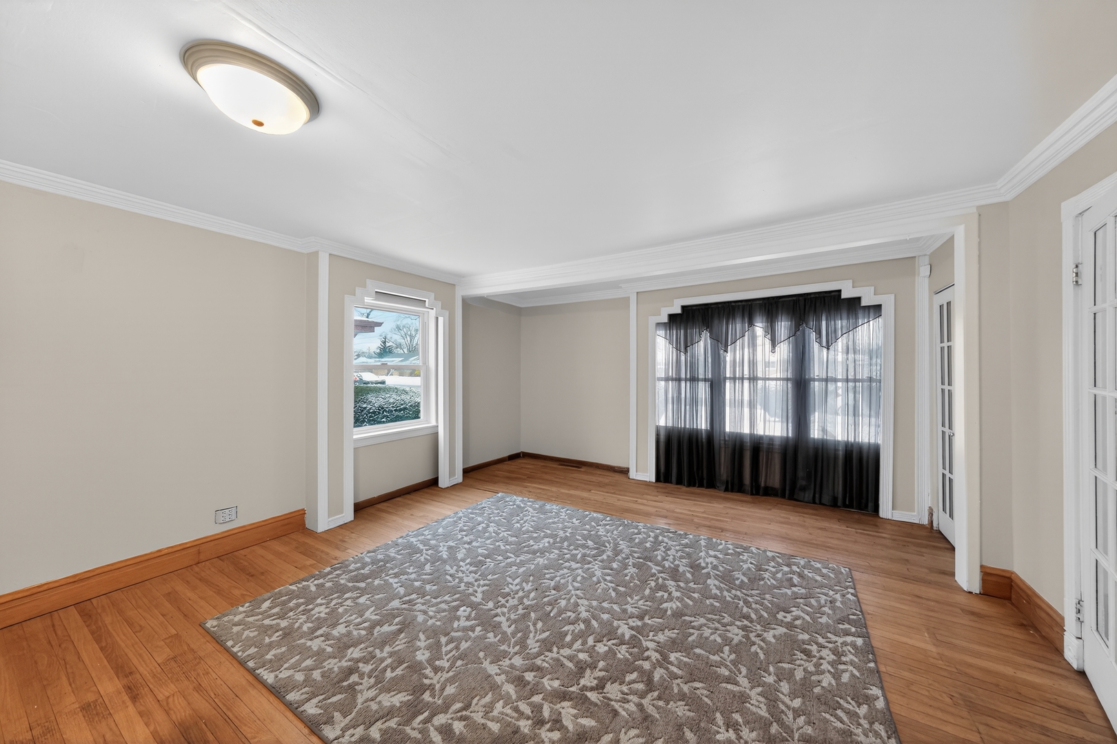 7315 Arcadia Street Morton Grove, IL 60053 - Photo 12 of 15 wooden floor in an empty room with a window