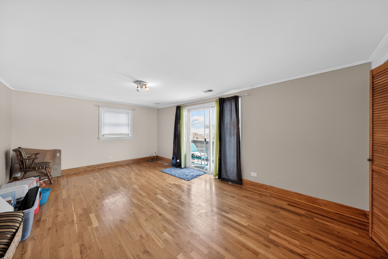 7315 Arcadia Street Morton Grove, IL 60053 - Photo 5 of 15 a view of an empty room with wooden floor and a window