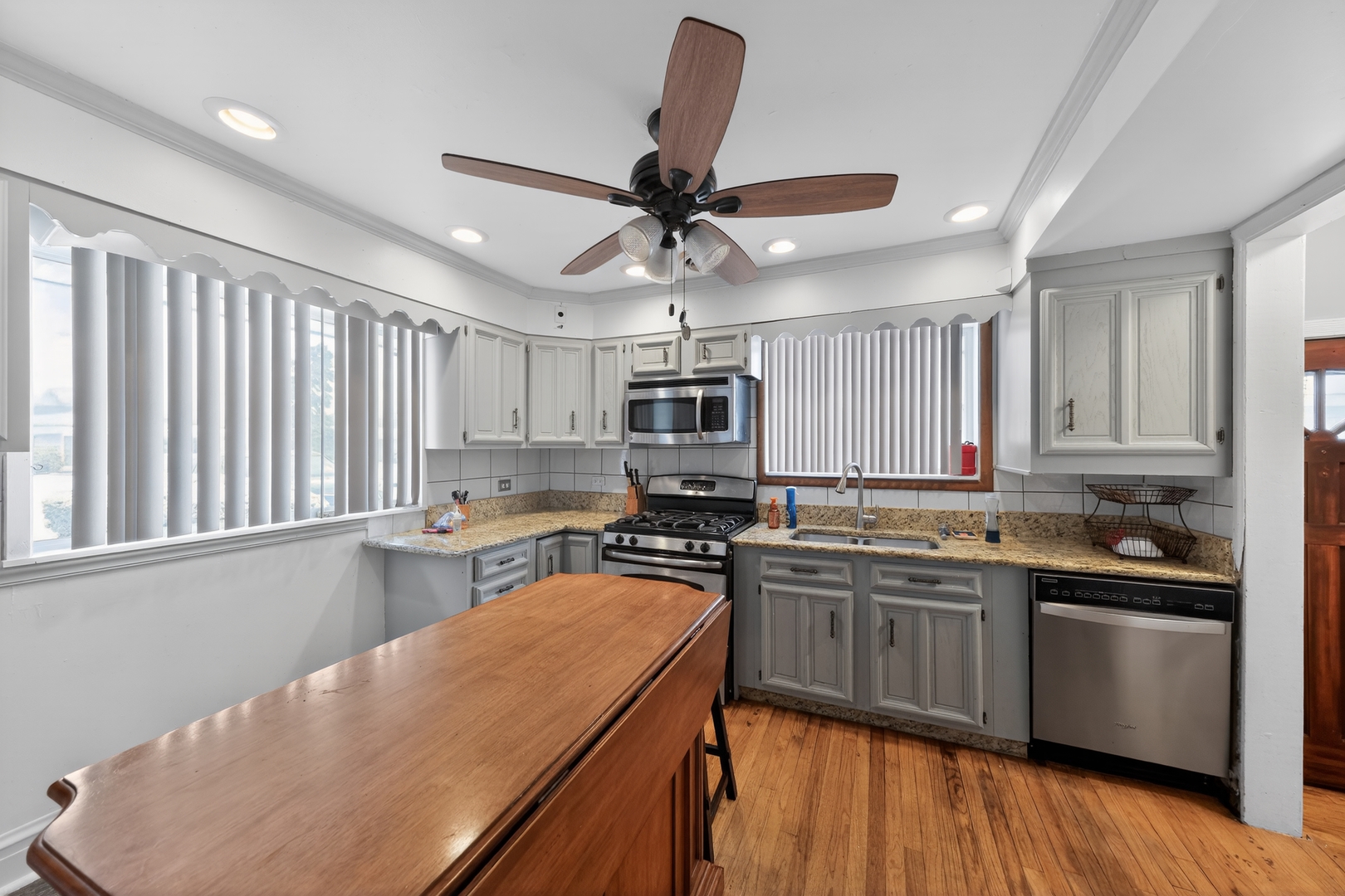 7315 Arcadia Street Morton Grove, IL 60053 - Photo 7 of 15 a kitchen with stainless steel appliances granite countertop a sink stove and refrigerator