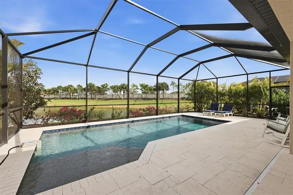 a view of a patio with a table and chairs under an umbrella