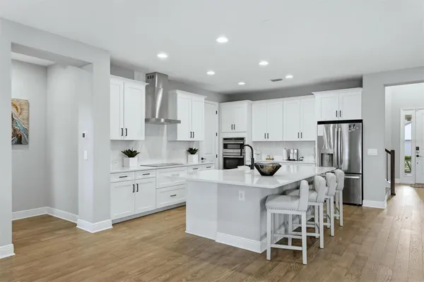 a view of entryway and hall with wooden floor