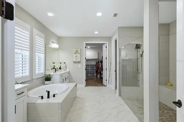 a kitchen with kitchen island granite countertop a sink a counter space appliances and cabinets