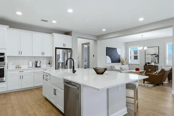a kitchen with white cabinets and white appliances