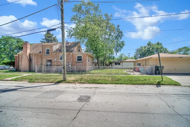 a view of street along with house and trees