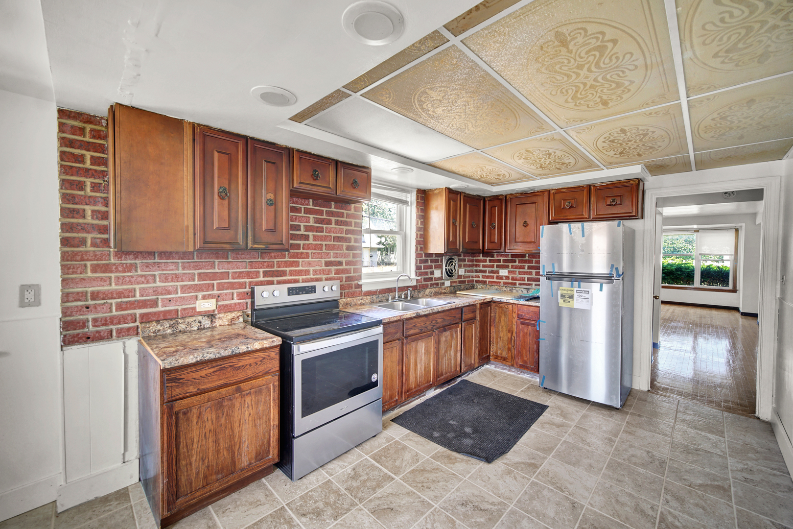 14528 Grant Street Dolton, IL 60419 - Photo 9 of 26 a kitchen with stainless steel appliances granite countertop a refrigerator stove and sink