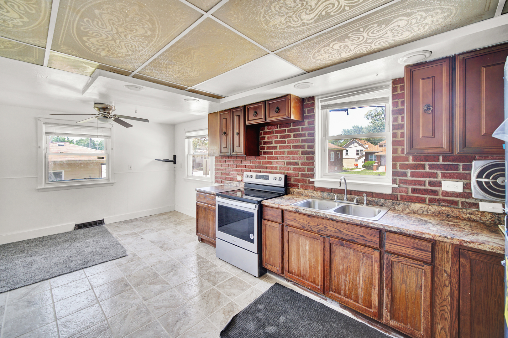 14528 Grant Street Dolton, IL 60419 - Photo 10 of 26 a kitchen with stainless steel appliances granite countertop a sink stove and cabinets