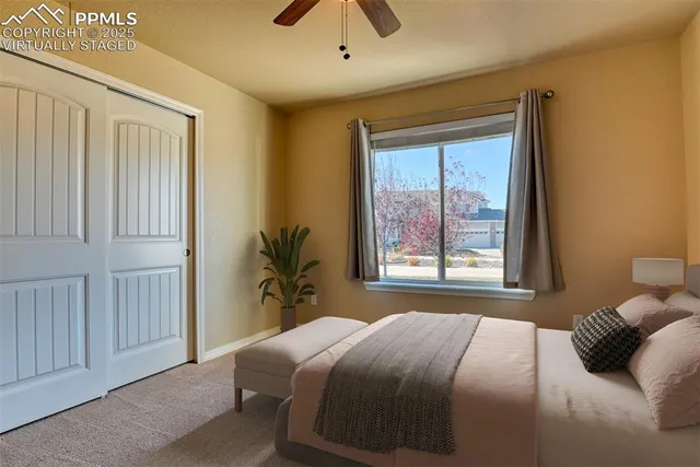 a bedroom with a large bed and a large window