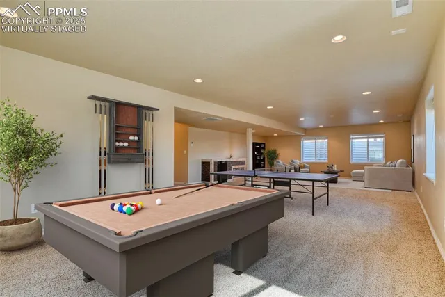 a living room with dining table and paintings on the wall