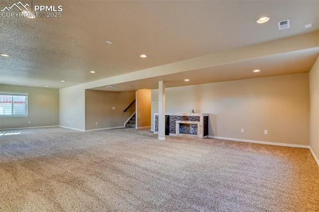 a view of an empty room with a fireplace