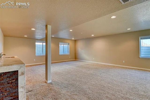 a view of an empty room with a kitchen