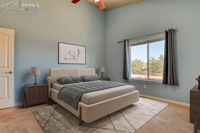 a bedroom with a bed couch and next to a window