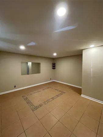 an empty room with a empty space and windows
