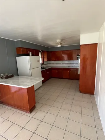 a room with washing machine and a view of couch