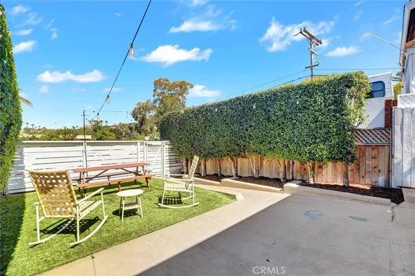 a view of a workspace with furniture and wooden floor