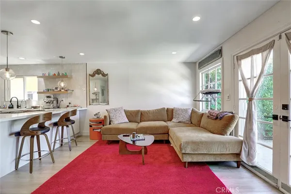 a kitchen that has a sink a stove and a table in it