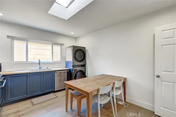 a bedroom with a bed a table and large windows