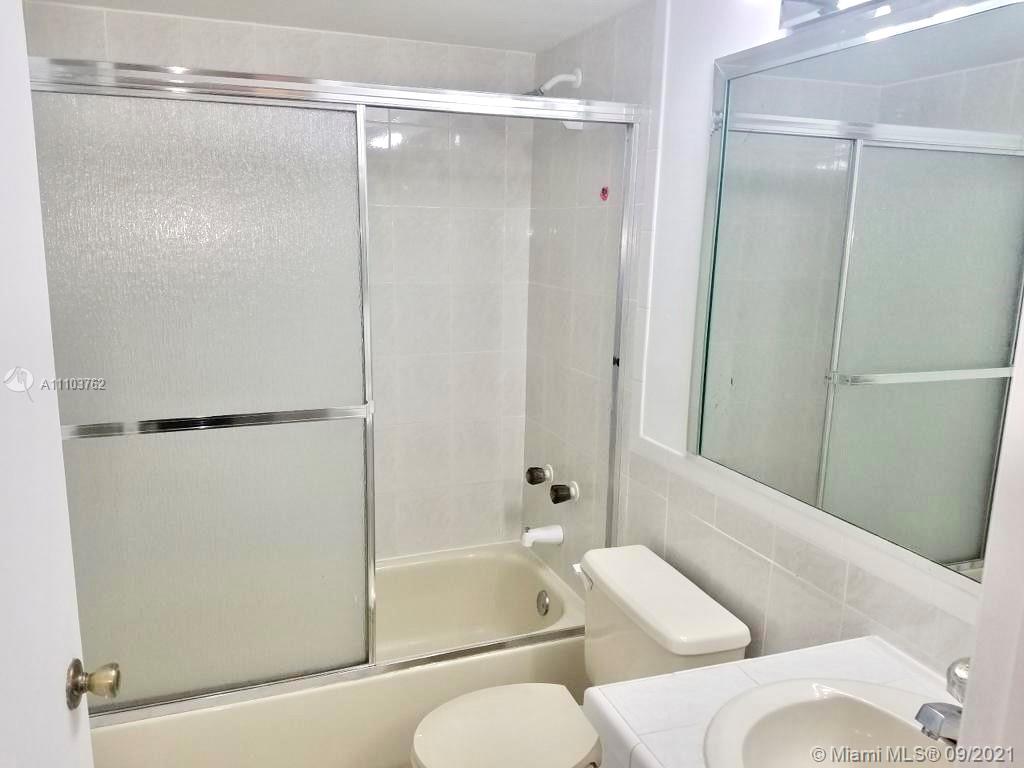 11790 Southwest 18th Street, Unit 1073 Miami, FL 33175 - Photo 14 of 18 a bathroom with a shower and a tub