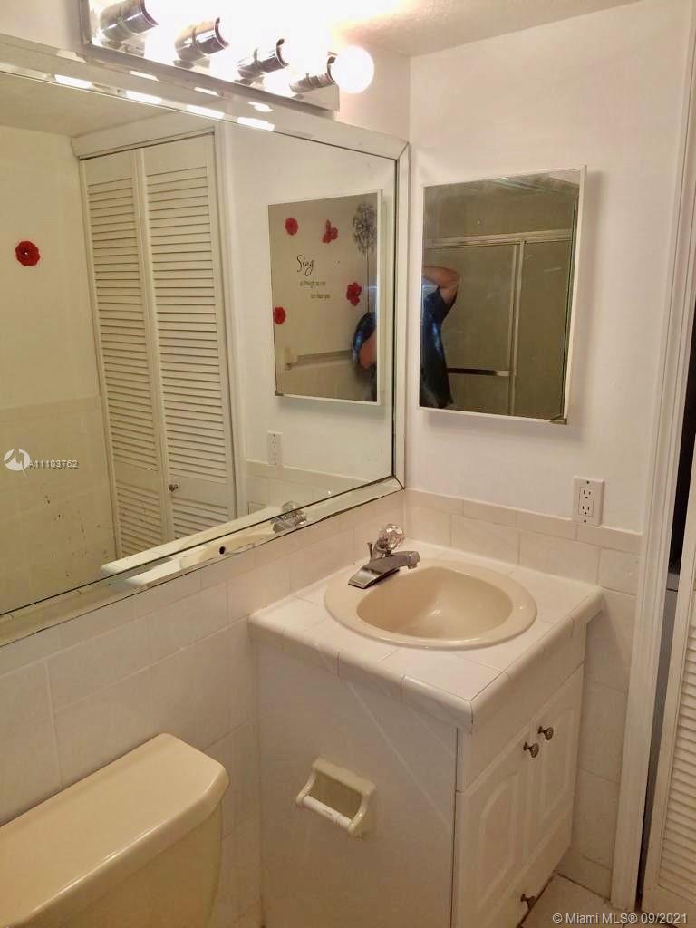 11790 Southwest 18th Street, Unit 1073 Miami, FL 33175 - Photo 15 of 18 a bathroom with a sink and a mirror