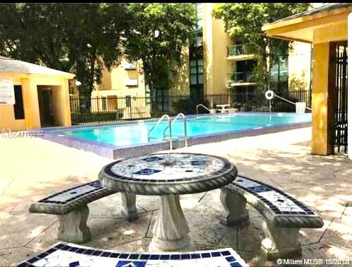 11790 Southwest 18th Street, Unit 1073 Miami, FL 33175 - Photo 18 of 18 a swimming pool with barbeque oven outdoor seating