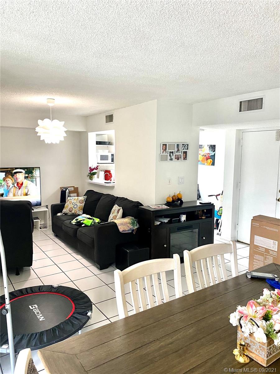 11790 Southwest 18th Street, Unit 1073 Miami, FL 33175 - Photo 6 of 18 a living room with furniture and a wooden floor
