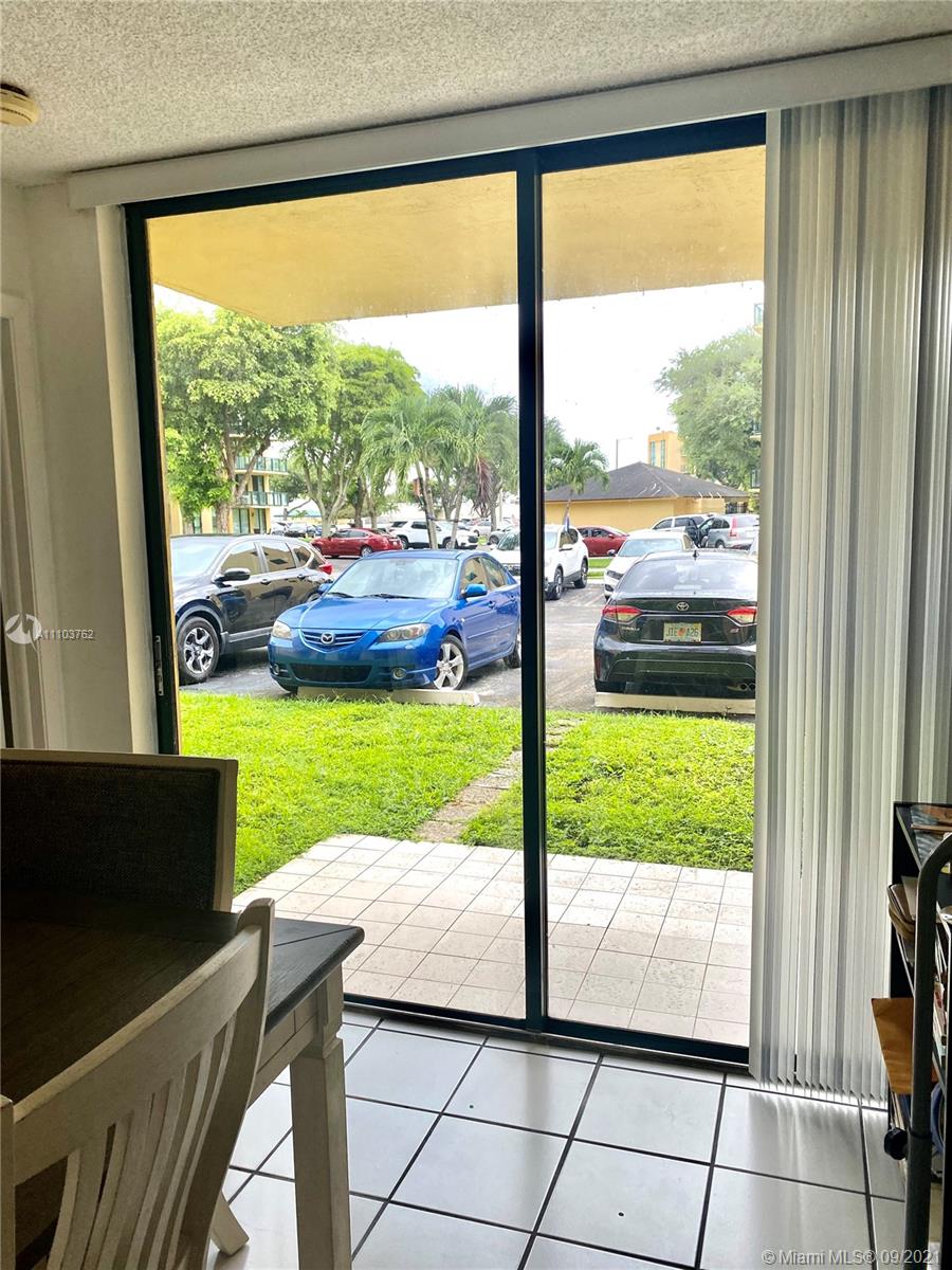 11790 Southwest 18th Street, Unit 1073 Miami, FL 33175 - Photo 8 of 18 a view of back yard from a window