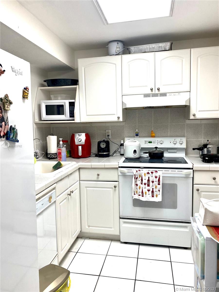 11790 Southwest 18th Street, Unit 1073 Miami, FL 33175 - Photo 9 of 18 a kitchen with stainless steel appliances granite countertop a sink and cabinets