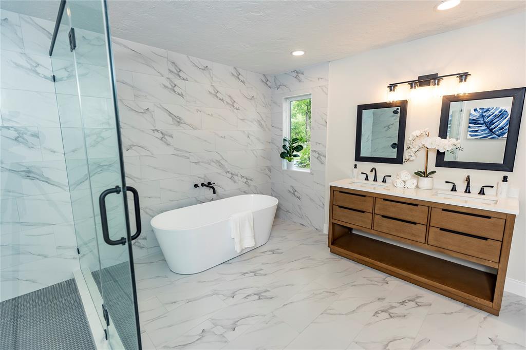 a bathroom with a sink mirror and a bathtub