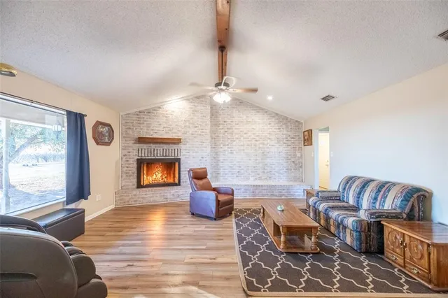 a living room with furniture window and wooden floor