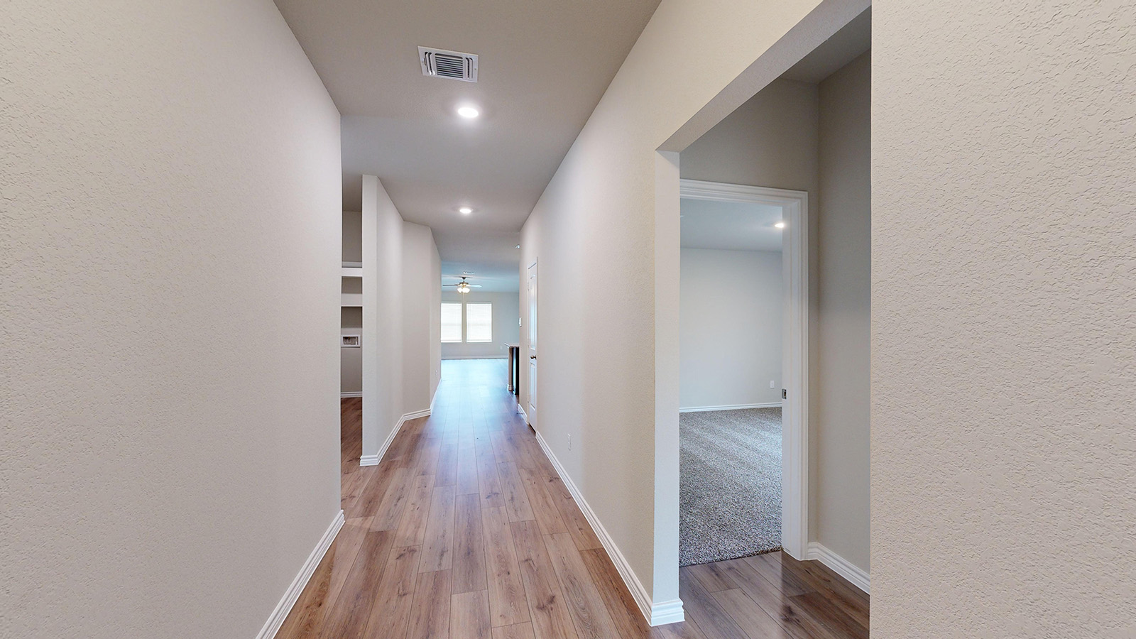 404 Creekfall Road Burnet, TX 78611 - Photo 2 of 23 Hall with a textured wall, light wood-style flooring, and recessed lighting