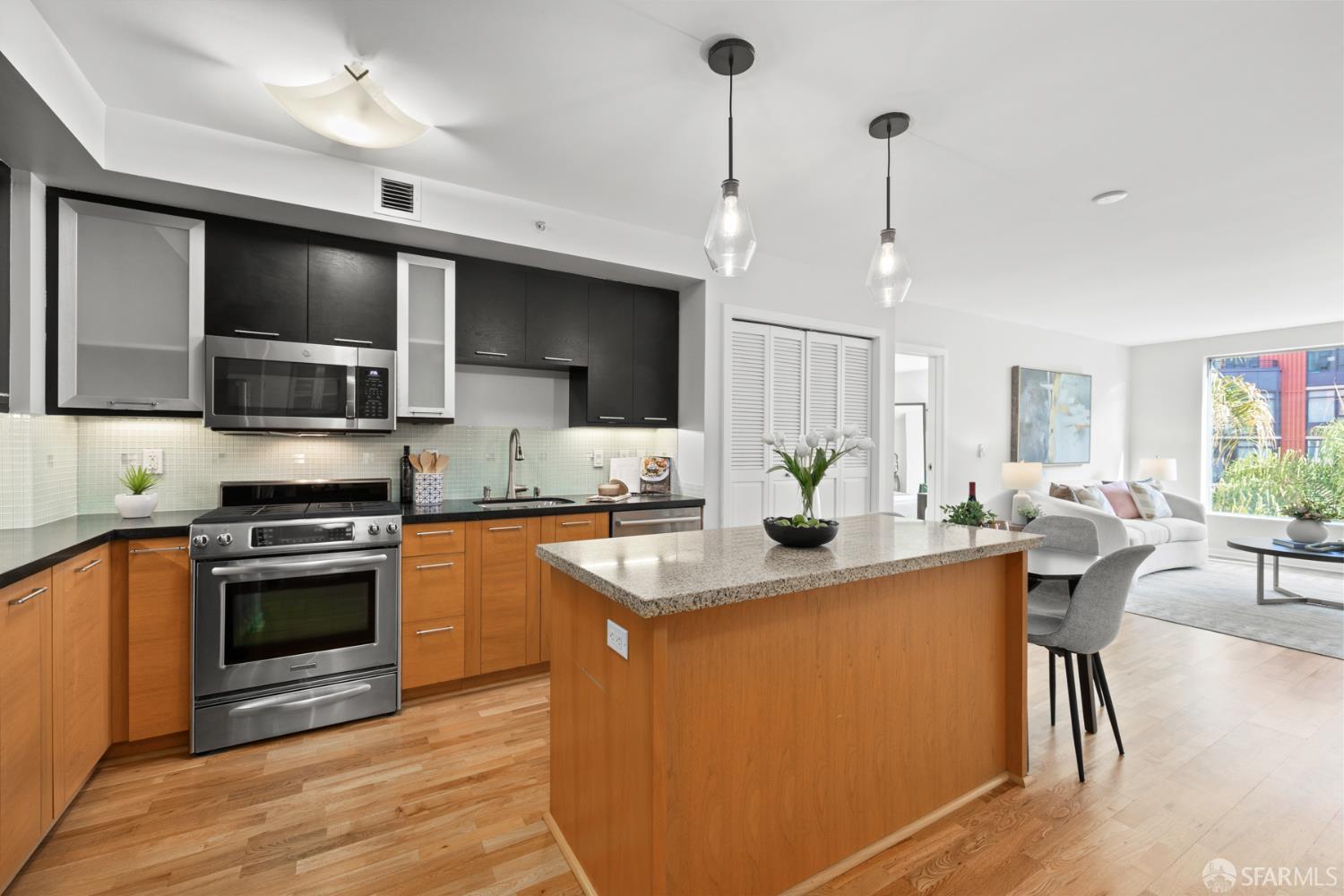 177 Townsend Street, Unit 728 San Francisco, CA 94107 - Photo 4 of 39 a kitchen with stainless steel appliances granite countertop a sink a stove top oven a counter space and cabinets