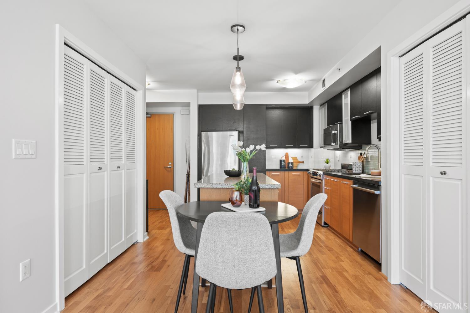 177 Townsend Street, Unit 728 San Francisco, CA 94107 - Photo 7 of 39 a dining room with stainless steel appliances kitchen island granite countertop a dining table chairs and granite counter tops