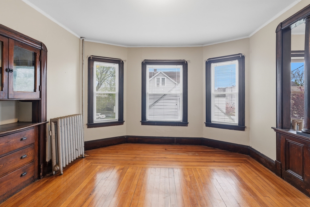 43 Elmdale Street, Unit 2 West Springfield, MA 01089 - Photo 4 of 14 a view of an empty room with window and wooden floor