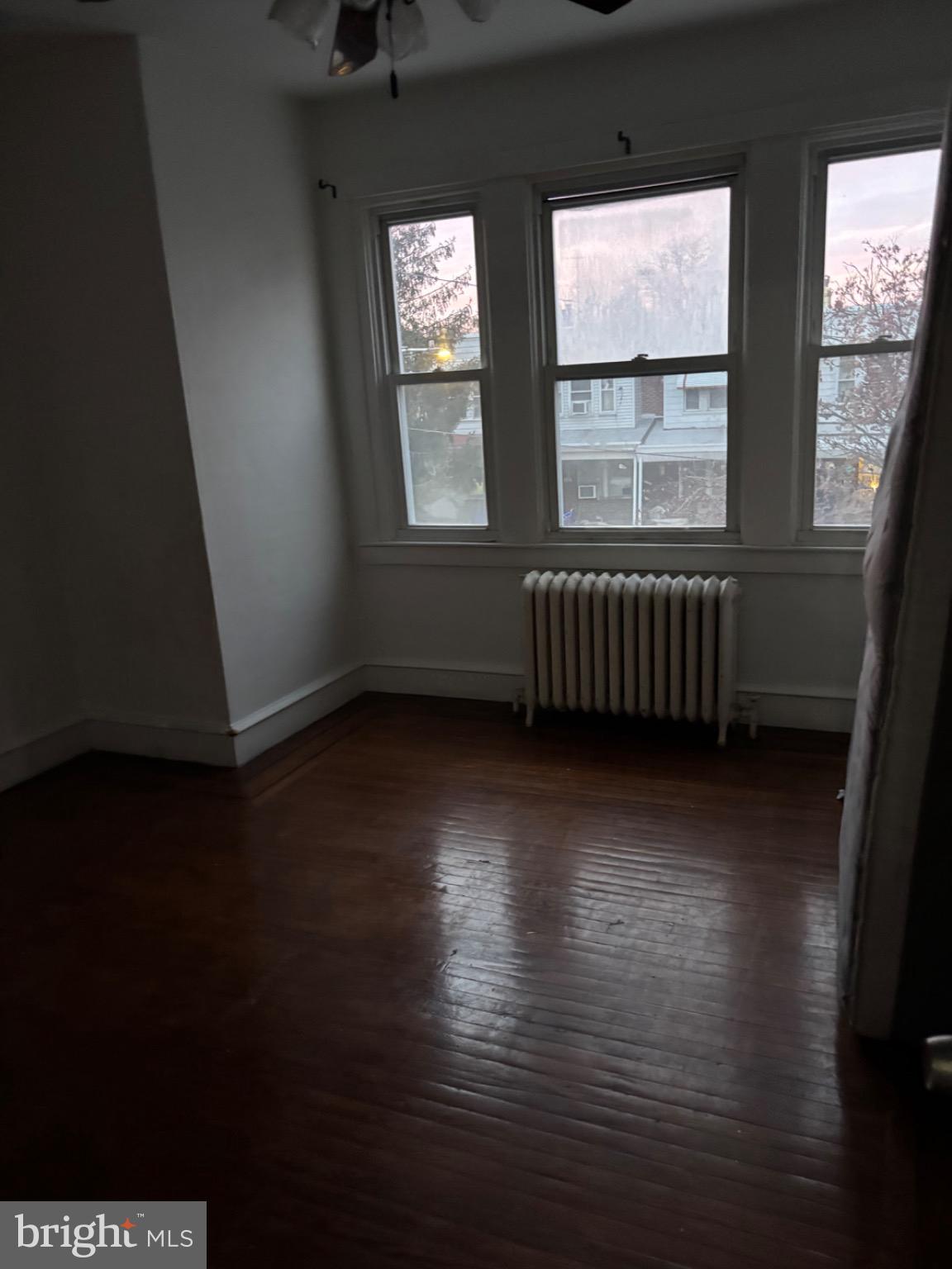 5223 Sylvester Street Philadelphia, PA 19124 - Photo 11 of 12 a view of an empty room with wooden floor and a window
