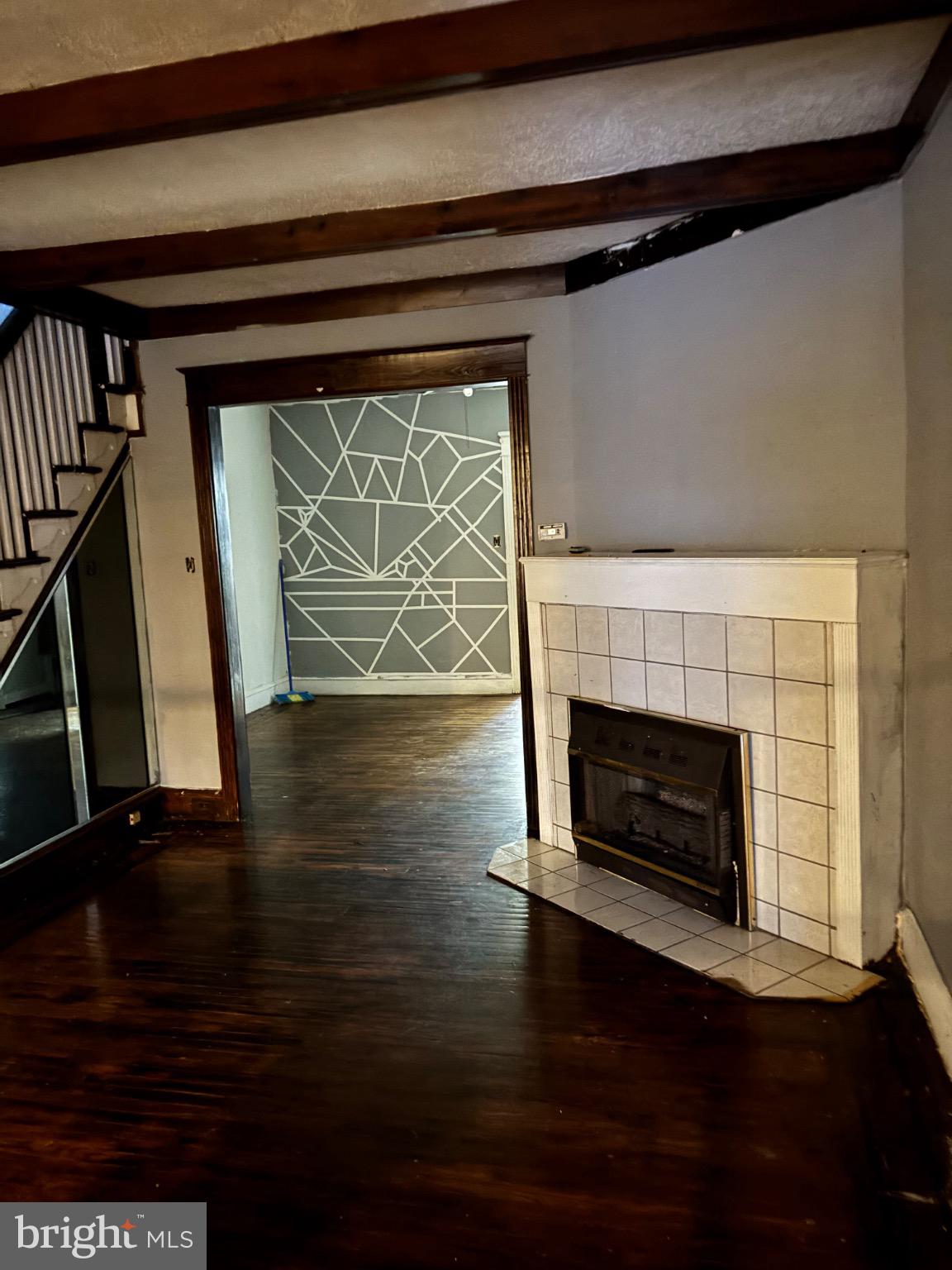 5223 Sylvester Street Philadelphia, PA 19124 - Photo 4 of 12 a living room with wooden floors and a fireplace