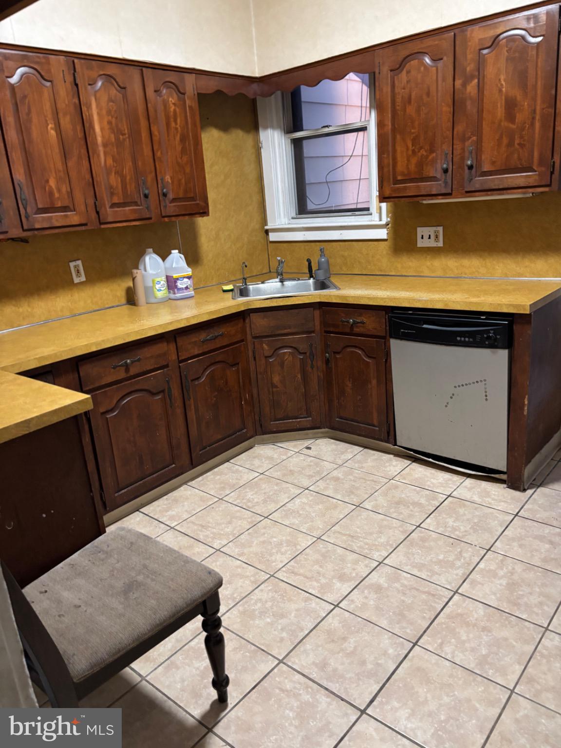 5223 Sylvester Street Philadelphia, PA 19124 - Photo 5 of 12 a kitchen with stainless steel appliances granite countertop a stove a sink and a microwave