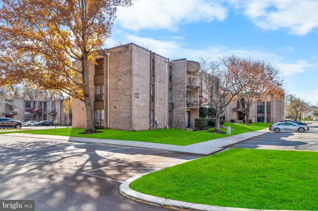 a view of a tall building next to a big yard