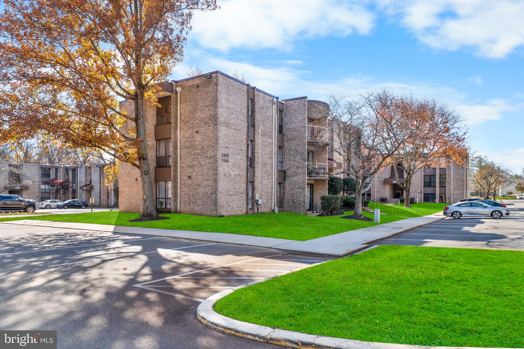3340 Huntley Square Drive, Unit A Temple Hills, MD 20748 - Photo 1 of 19 a view of a tall building next to a big yard