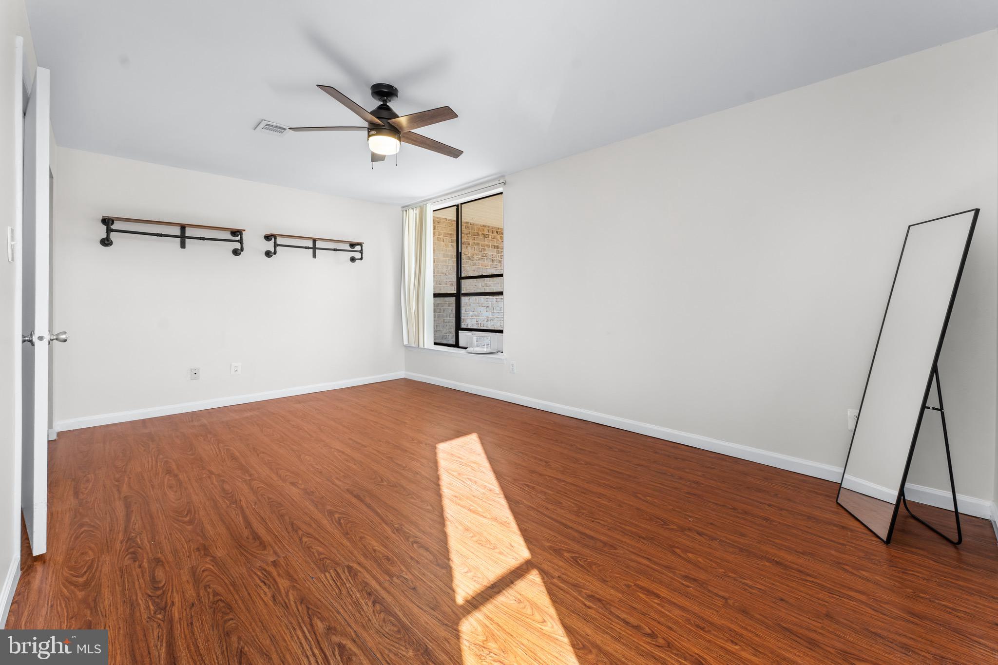 3340 Huntley Square Drive, Unit A Temple Hills, MD 20748 - Photo 13 of 19 a view of a room with wooden floor and ceiling fan
