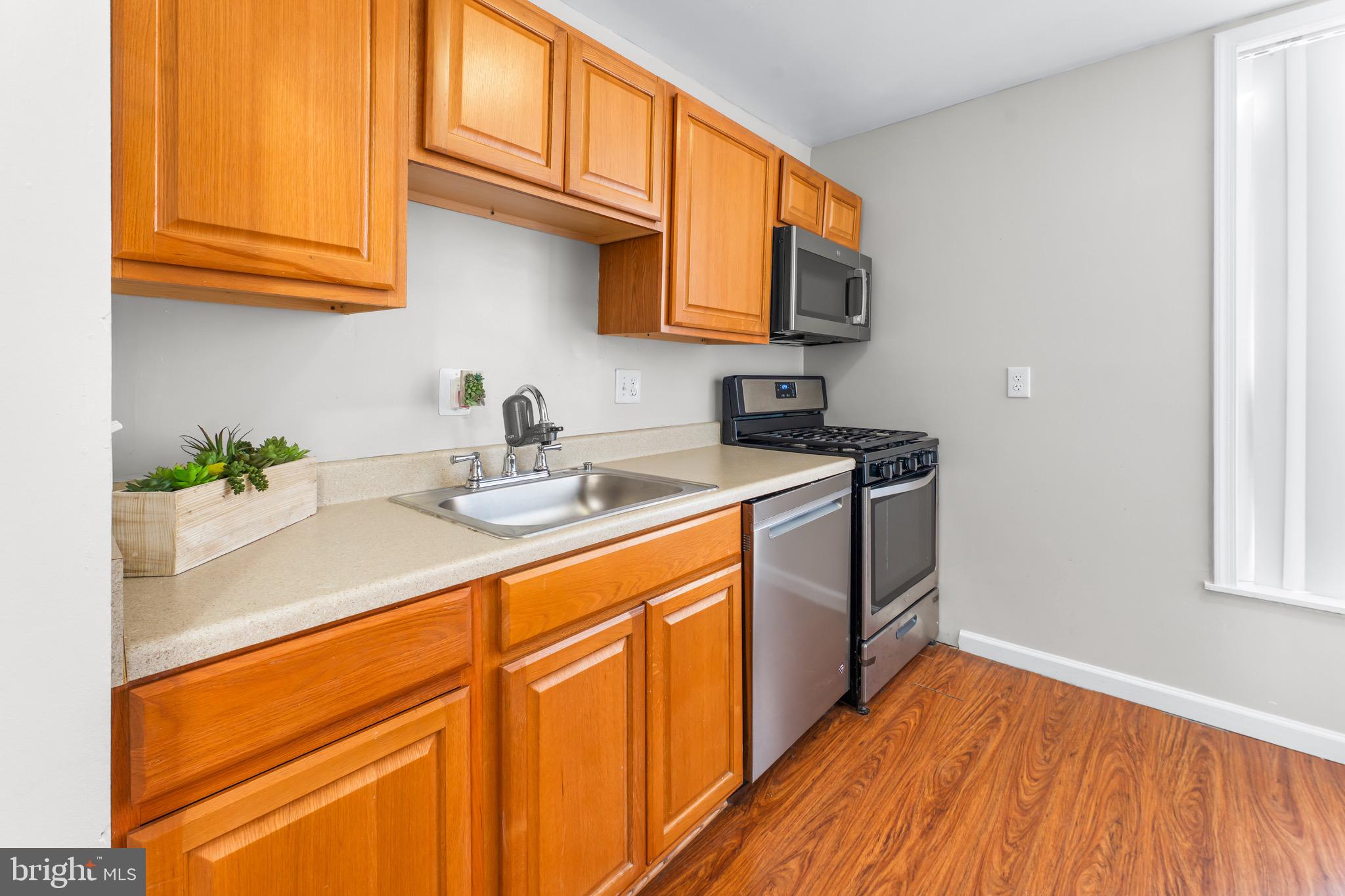 3340 Huntley Square Drive, Unit A Temple Hills, MD 20748 - Photo 16 of 19 a kitchen with stainless steel appliances granite countertop wooden cabinets a sink and dishwasher