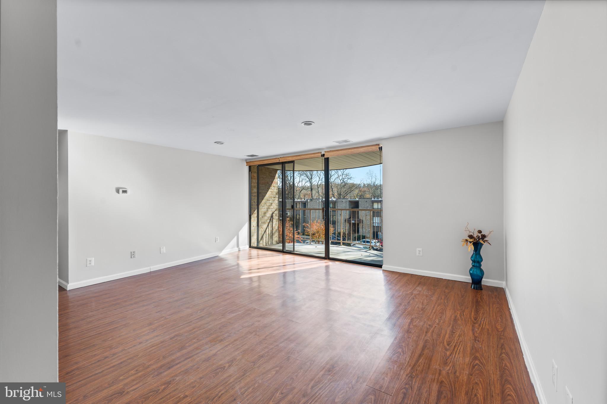 3340 Huntley Square Drive, Unit A Temple Hills, MD 20748 - Photo 3 of 19 wooden floor in an empty room with a window
