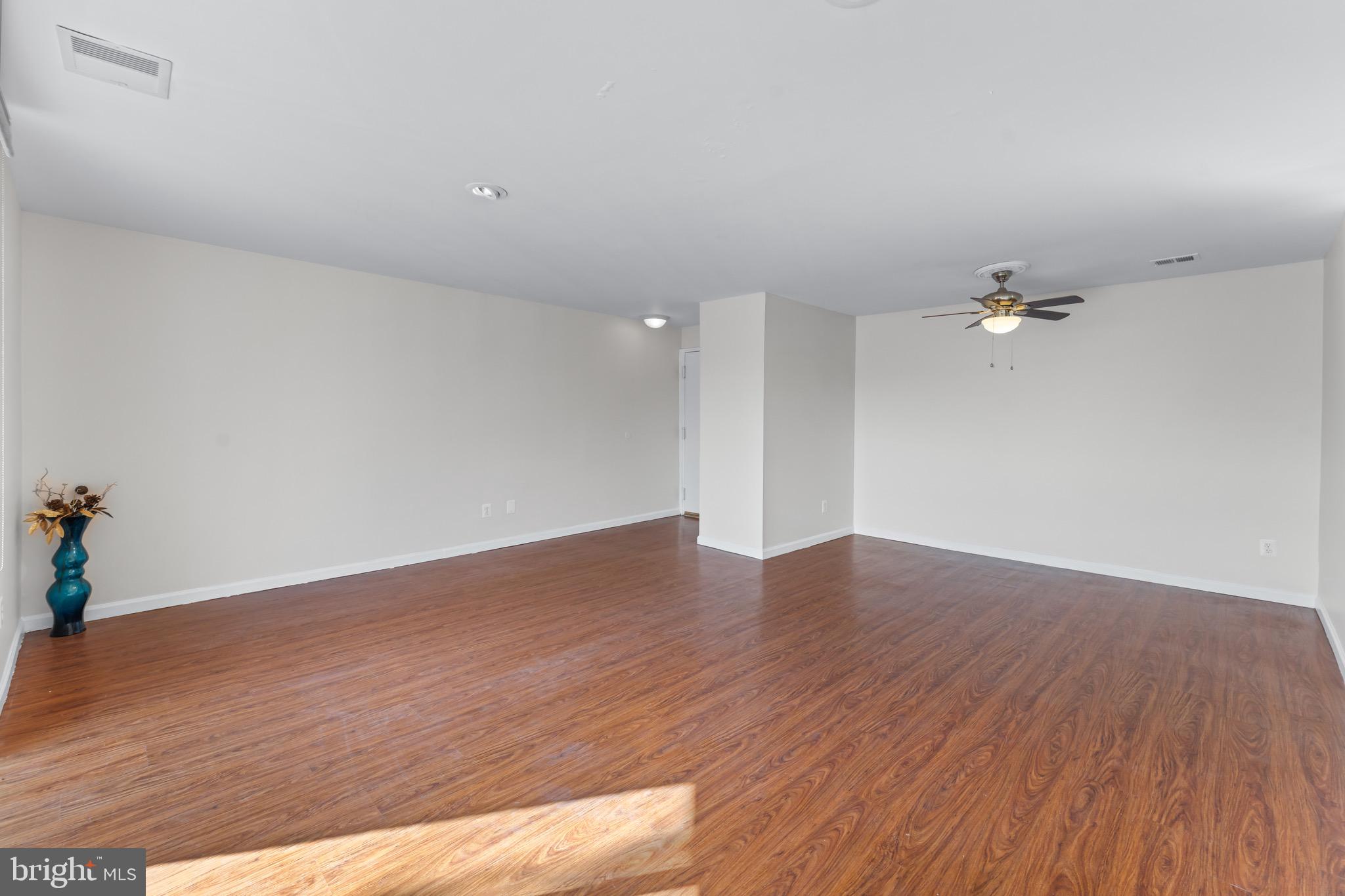 3340 Huntley Square Drive, Unit A Temple Hills, MD 20748 - Photo 4 of 19 an empty room with wooden floor and fan