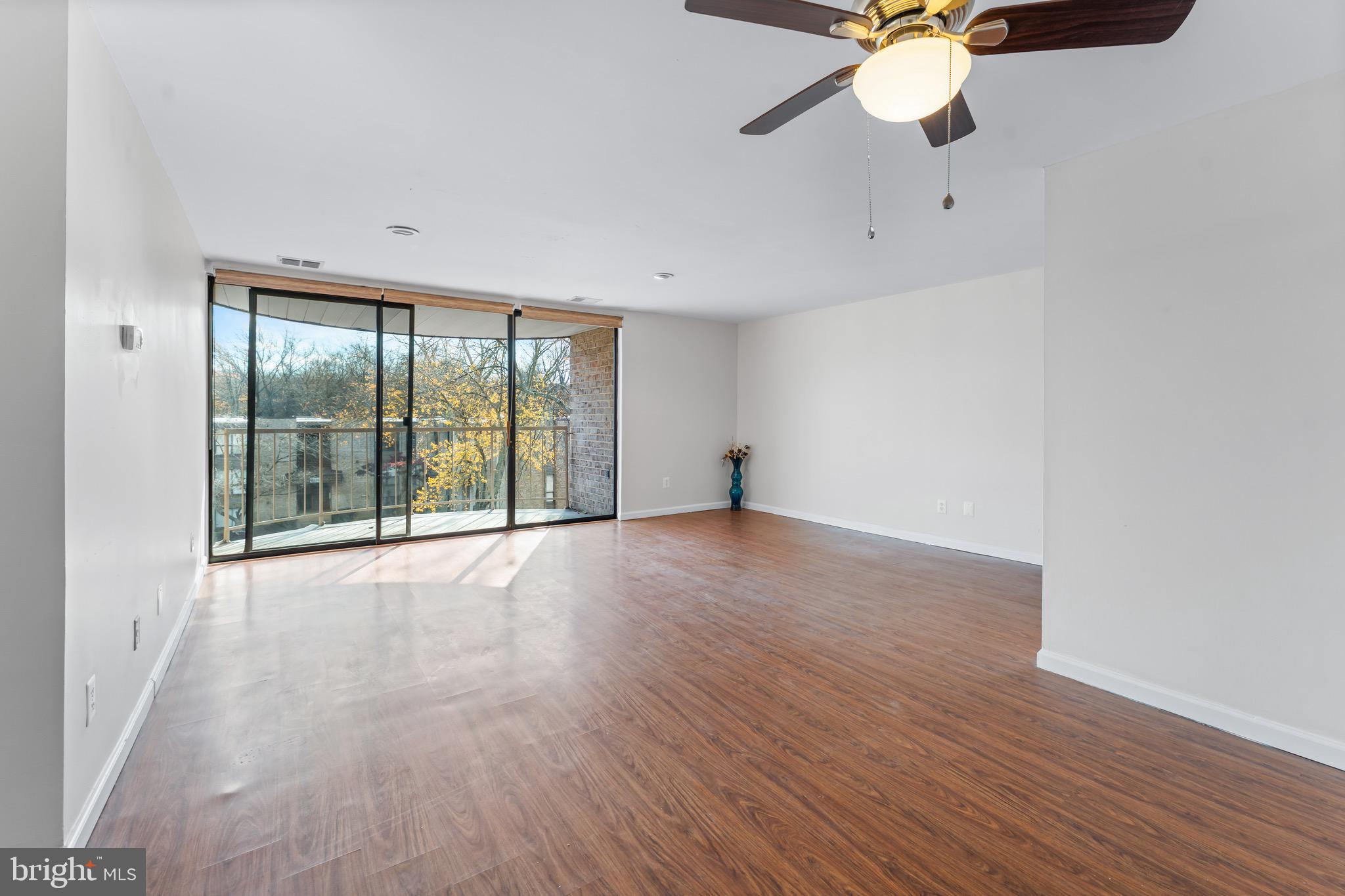 3340 Huntley Square Drive, Unit A Temple Hills, MD 20748 - Photo 7 of 19 an empty room with wooden floor fan and windows