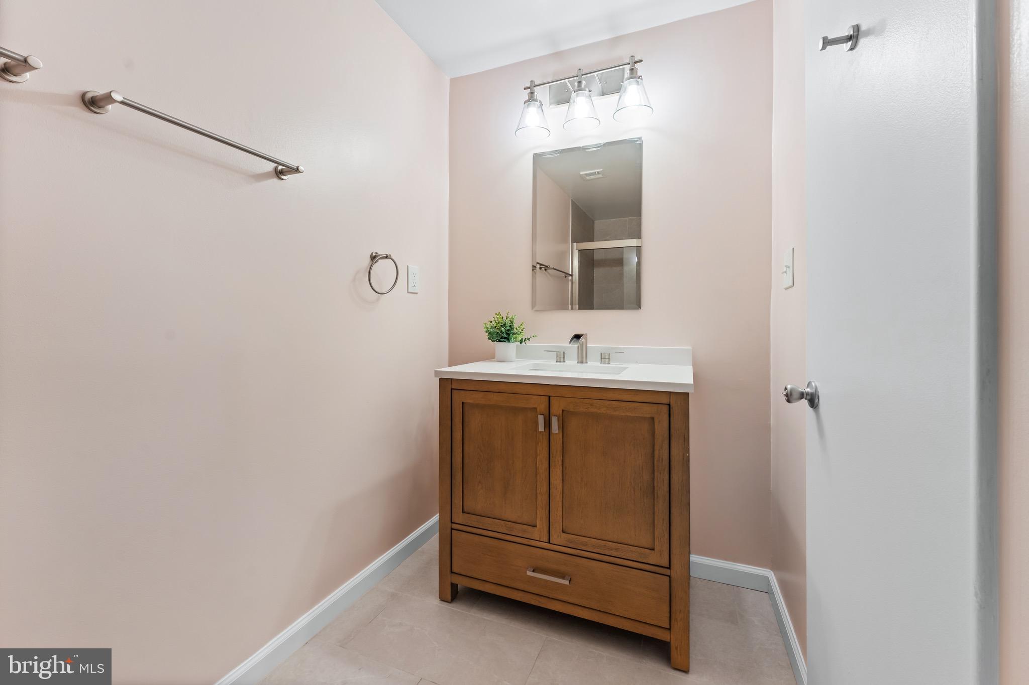 3340 Huntley Square Drive, Unit A Temple Hills, MD 20748 - Photo 9 of 19 a bathroom with a sink and a mirror